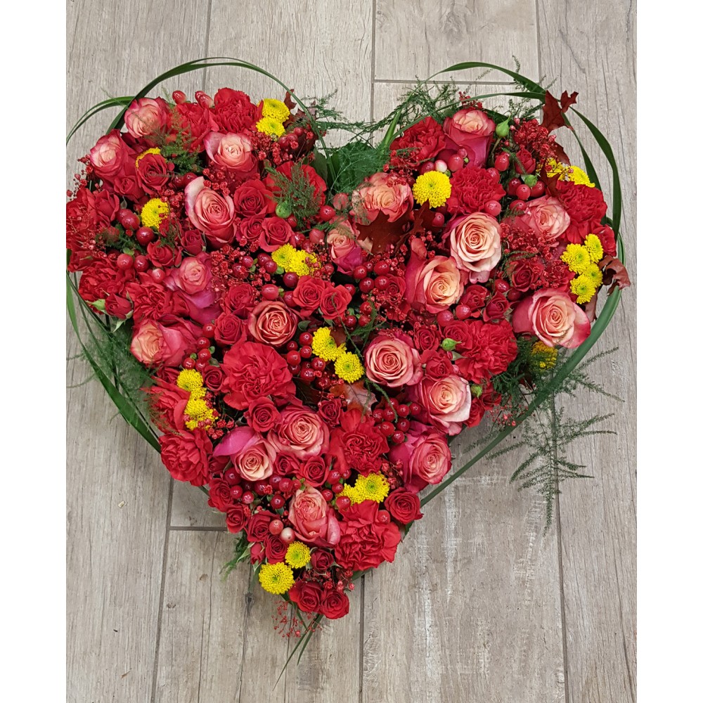 Fleurs piquées dans la mousse humide, décliné en plusieurs couleurs - Envergure 55 cm - Fleuriste Celles-sur-Belle (79)
